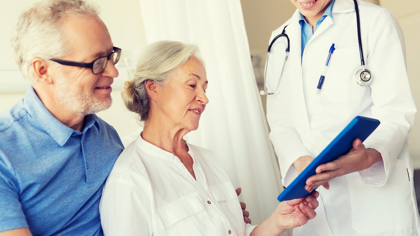 senior woman and doctor with tablet
