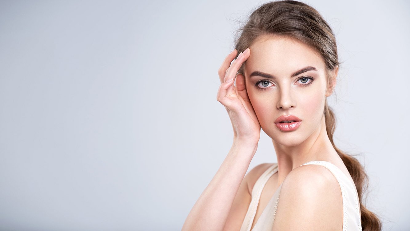 Portrait of a beautiful young woman with a brown hair.